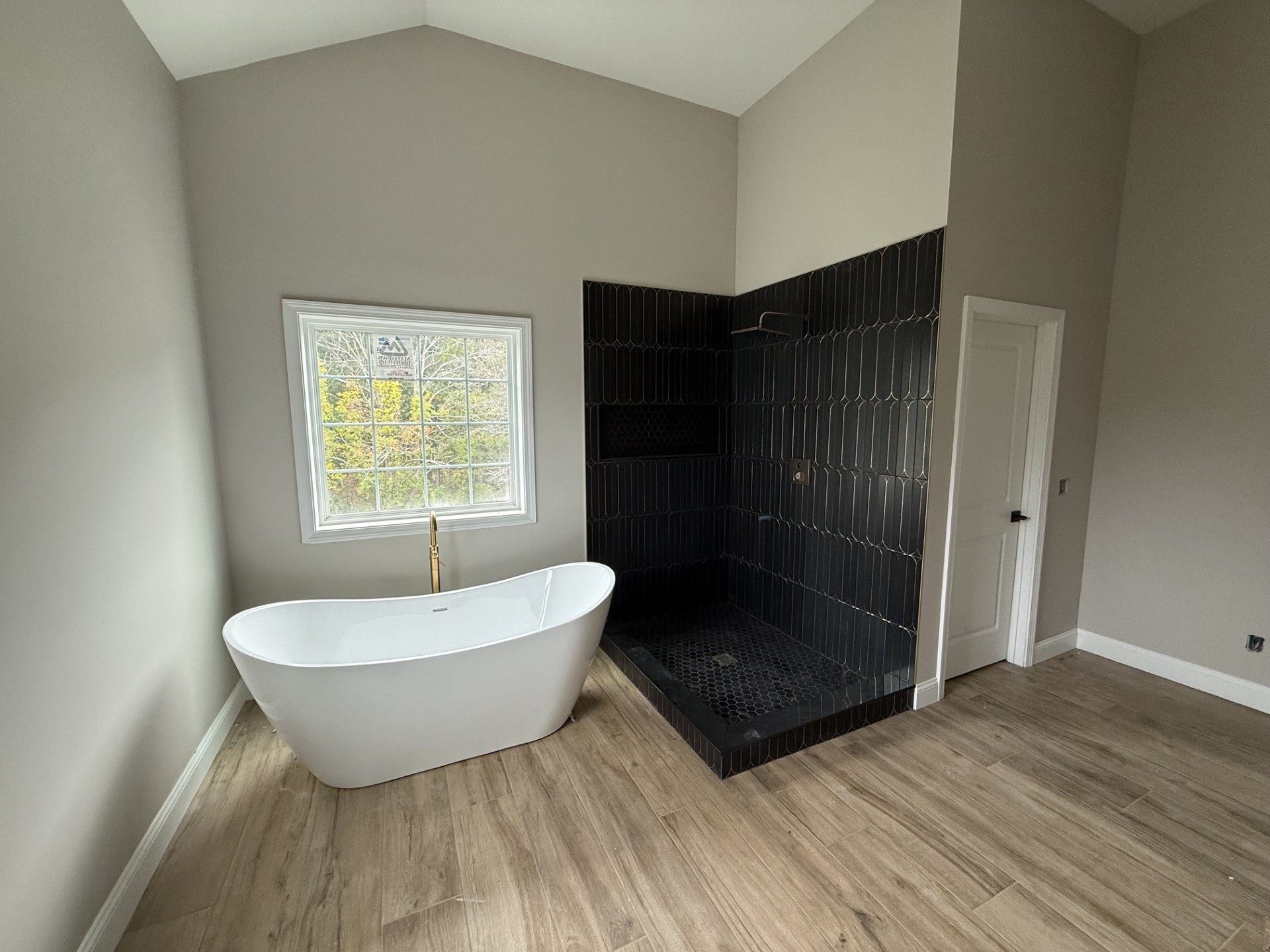 Primary bath with soaking tub and tiled shower